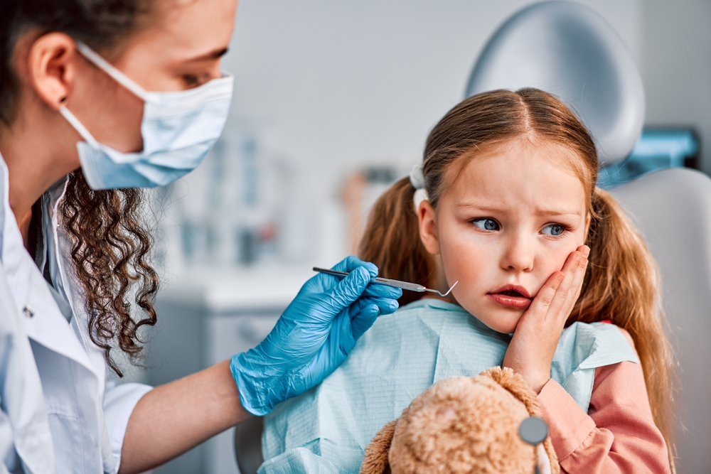 child at dentist with toothache